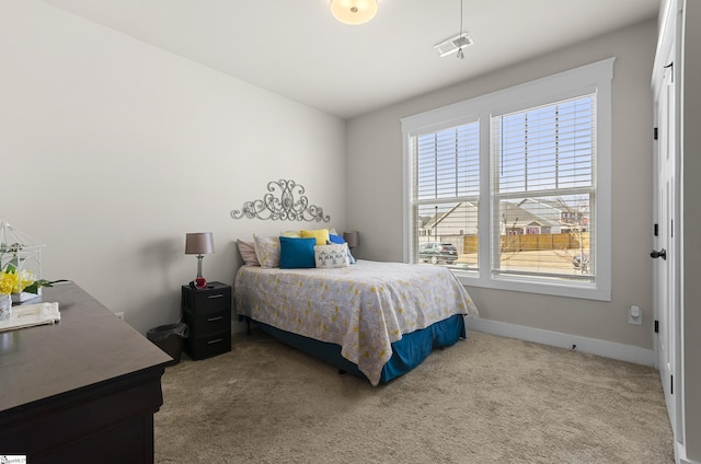 bedroom with carpet, visible vents, and baseboards