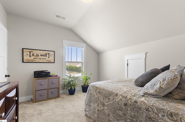 carpeted bedroom with vaulted ceiling, baseboards, and visible vents