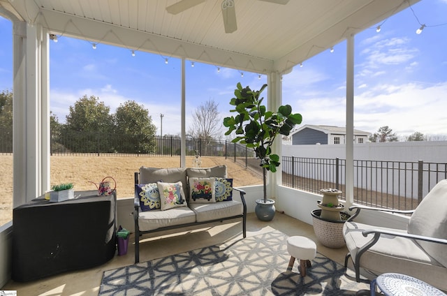 sunroom with a healthy amount of sunlight and ceiling fan