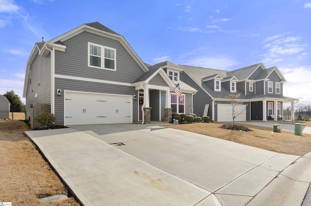 view of front of home featuring a garage, driveway, and fence