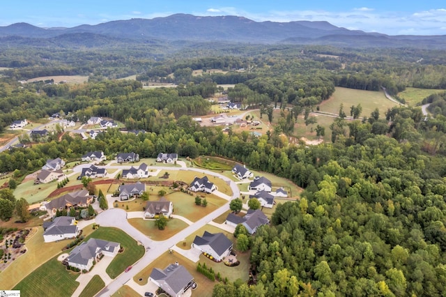 drone / aerial view featuring a mountain view, a forest view, and a residential view