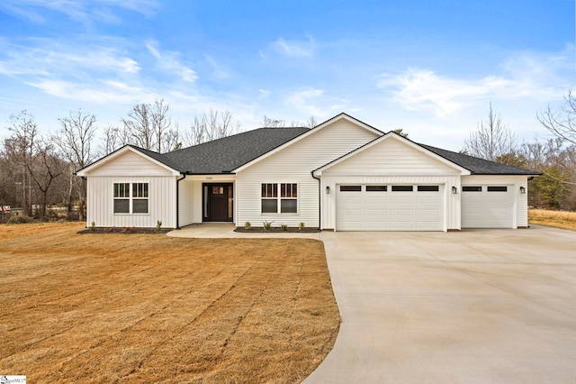 view of front facade featuring board and batten siding, concrete driveway, an attached garage, and a shingled roof