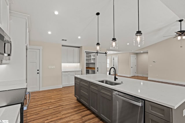 kitchen featuring visible vents, gray cabinets, a sink, stainless steel appliances, and white cabinets