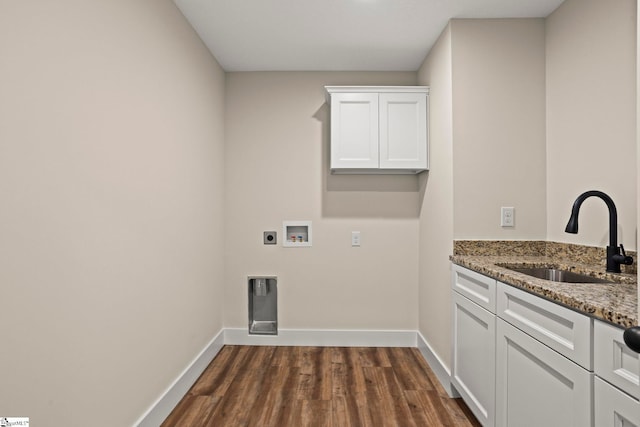 washroom with dark wood-style floors, cabinet space, baseboards, and a sink