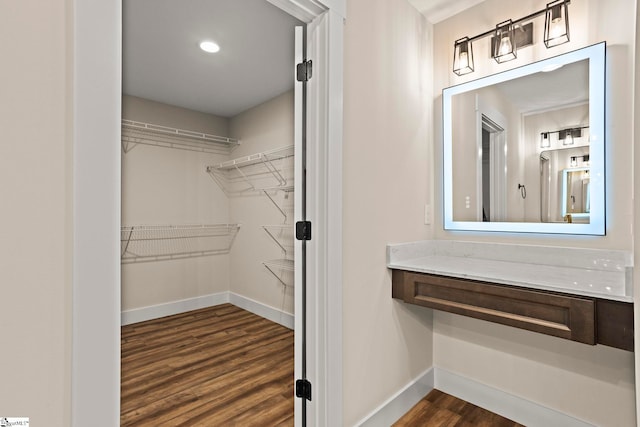 spacious closet featuring dark wood finished floors