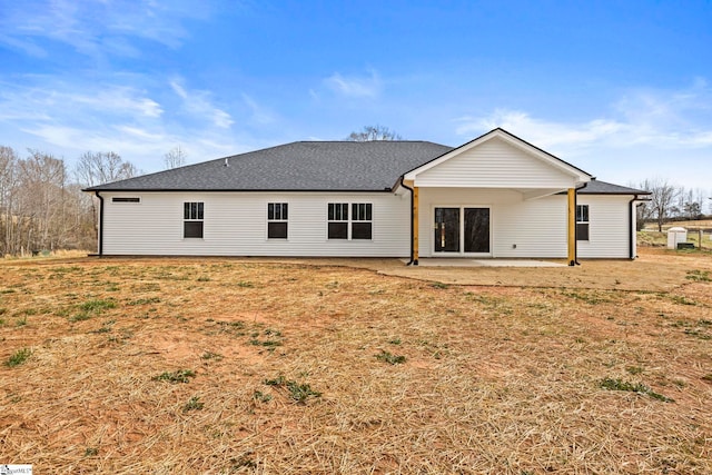 back of house featuring a patio area and a shingled roof