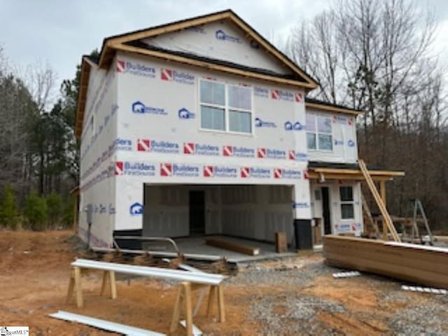 unfinished property featuring a garage