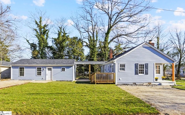 view of front facade with a deck, a front lawn, dirt driveway, crawl space, and a chimney