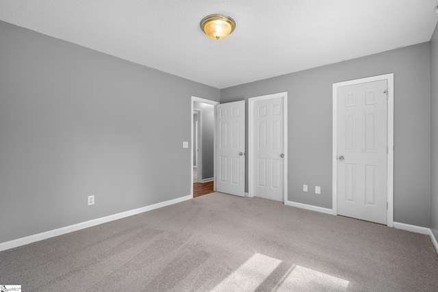 unfurnished bedroom with baseboards and carpet floors