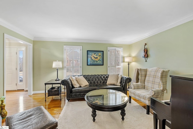 living room featuring wood finished floors, baseboards, and ornamental molding