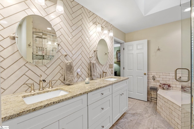 bathroom featuring a sink, tile walls, a stall shower, and double vanity