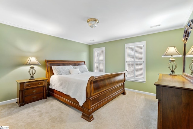 bedroom with visible vents, light carpet, baseboards, and crown molding