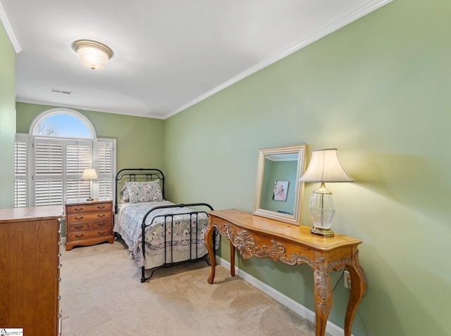 carpeted bedroom with visible vents, baseboards, and crown molding