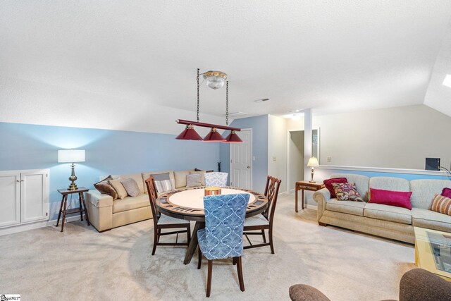 dining room with light colored carpet and vaulted ceiling