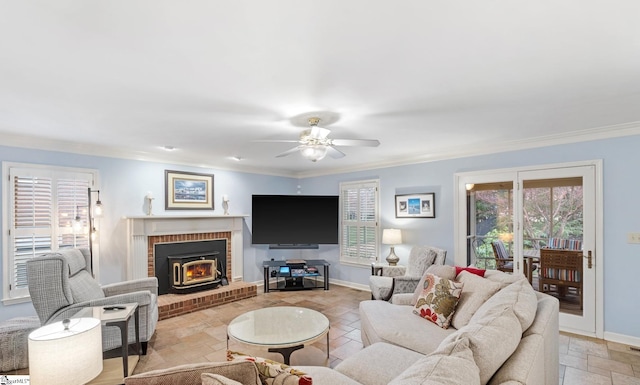 living area with stone tile floors, a ceiling fan, baseboards, and ornamental molding