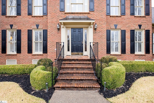 entrance to property with brick siding