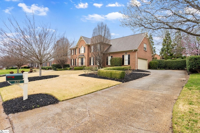 view of front of home with a garage, brick siding, and driveway