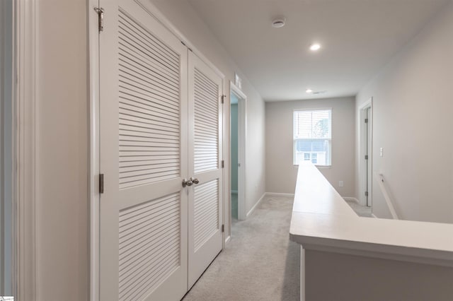 hall with recessed lighting, baseboards, and light carpet