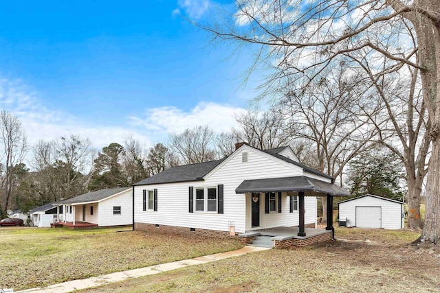 view of front of property featuring covered porch, an outdoor structure, a front lawn, a garage, and crawl space