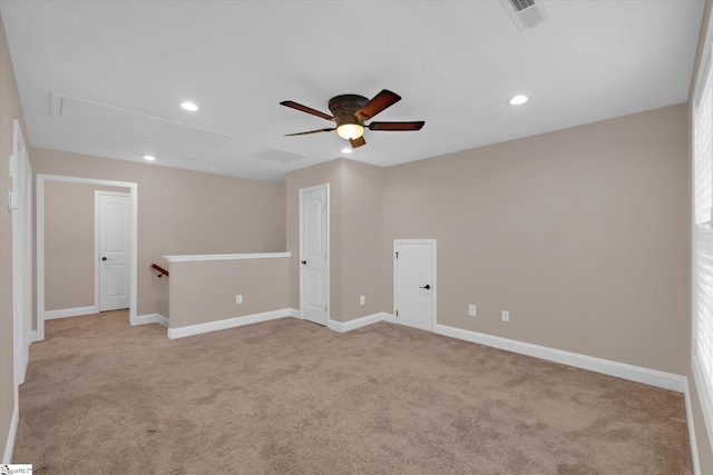 spare room with attic access, recessed lighting, baseboards, and light carpet