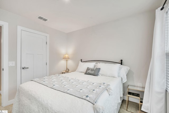 bedroom with baseboards, visible vents, and carpet floors