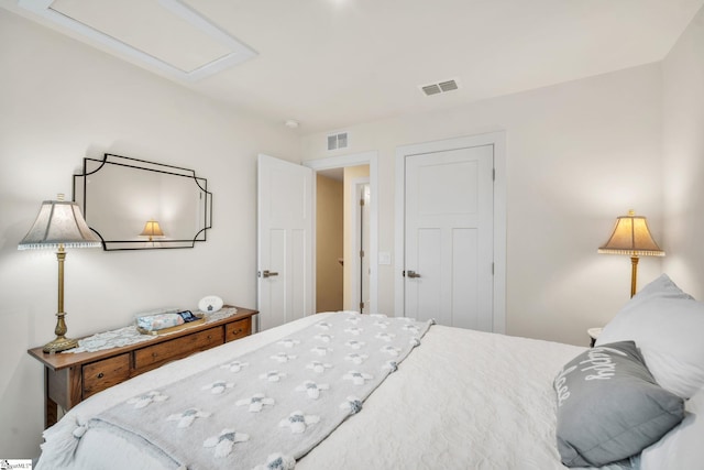 bedroom with visible vents and attic access