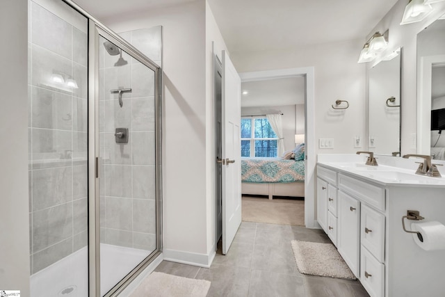 full bath featuring a sink, double vanity, a stall shower, and connected bathroom