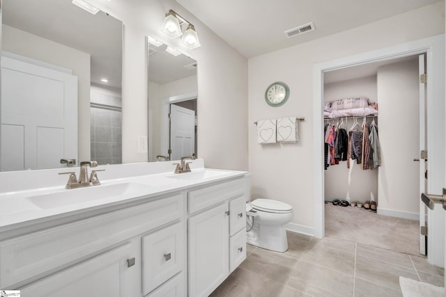 full bathroom featuring double vanity, visible vents, toilet, and a sink