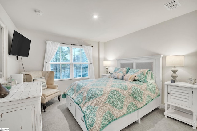 bedroom featuring light colored carpet and visible vents