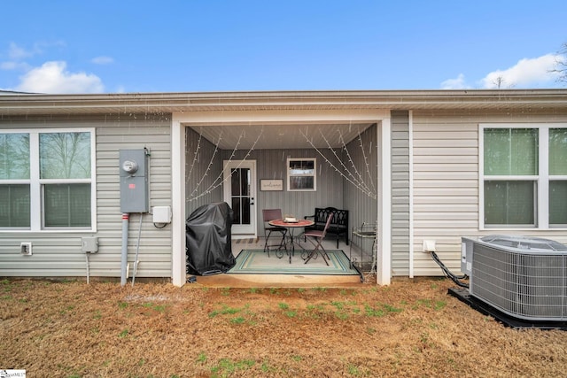 exterior space featuring central air condition unit and a patio area