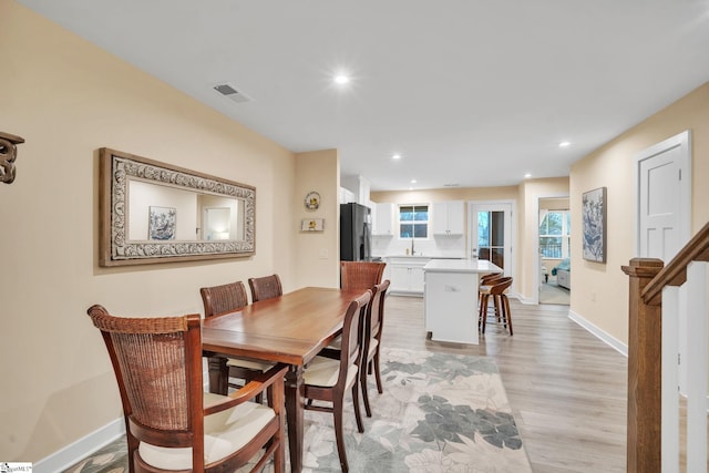 dining room with recessed lighting, visible vents, baseboards, and light wood finished floors