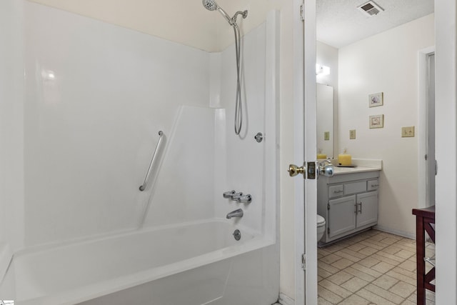 bathroom with vanity, visible vents, brick floor, bathtub / shower combination, and toilet