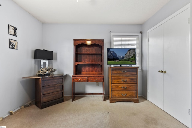 carpeted bedroom with a closet