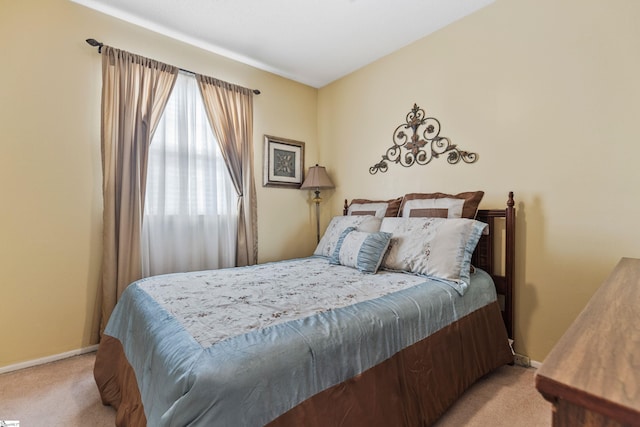 bedroom with light carpet and baseboards