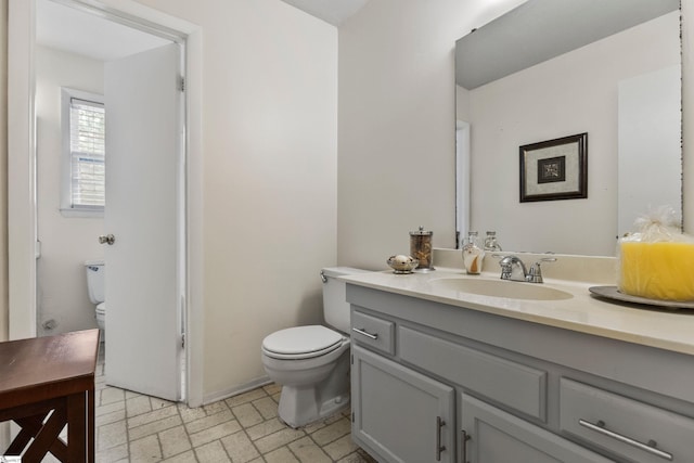 bathroom featuring toilet and vanity