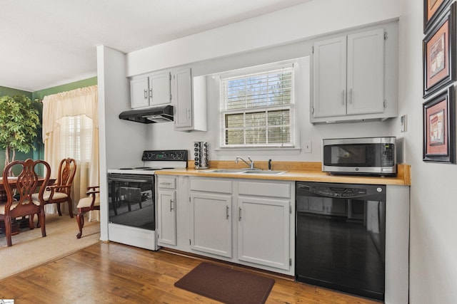 kitchen featuring stainless steel microwave, under cabinet range hood, black dishwasher, white electric range oven, and a sink