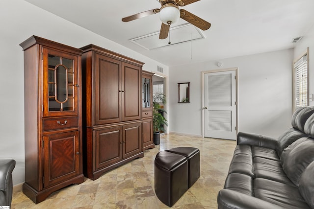 living room with visible vents, baseboards, and attic access