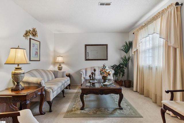 living area with light carpet and visible vents