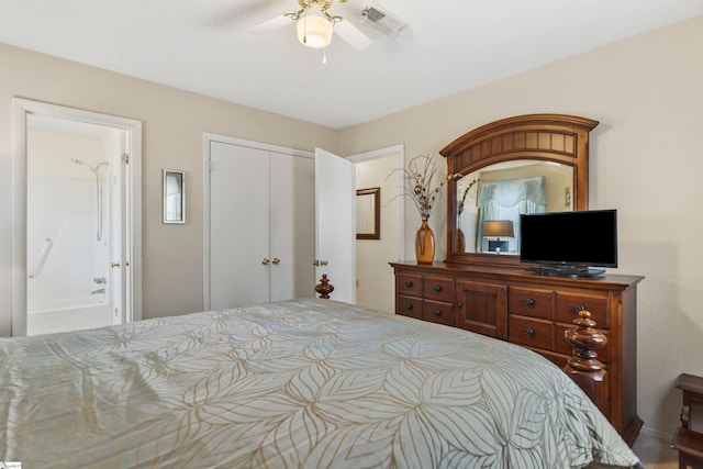 bedroom with a closet, visible vents, ensuite bath, and a ceiling fan