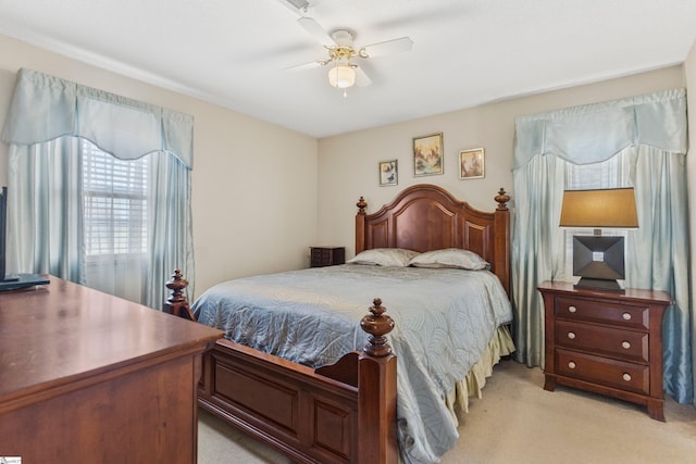 bedroom featuring ceiling fan and light carpet