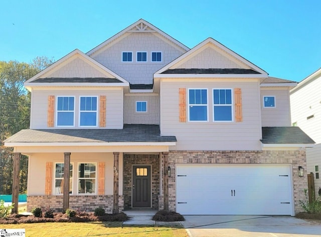 craftsman inspired home with concrete driveway, a porch, and a garage