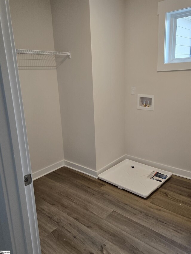 laundry room with washer hookup, laundry area, baseboards, and dark wood-style flooring