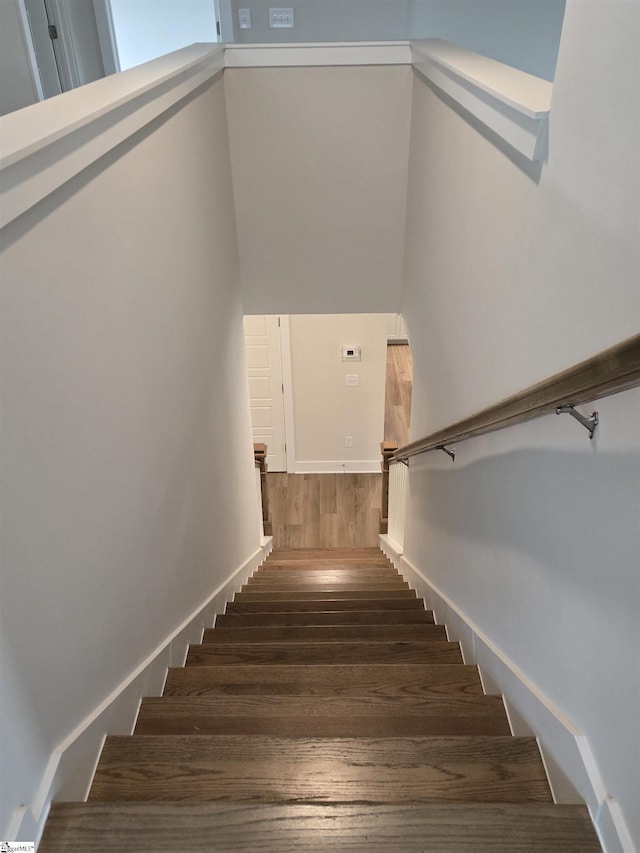 stairway with wood finished floors