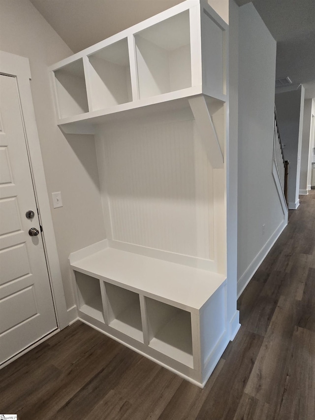 mudroom featuring dark wood-style floors, visible vents, and baseboards