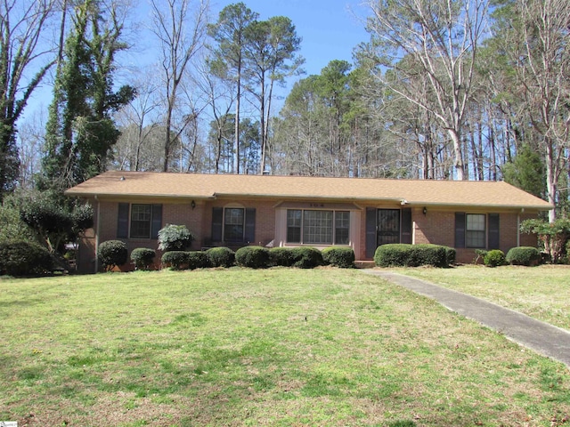 ranch-style house with brick siding and a front lawn