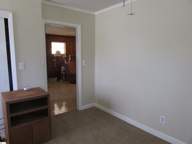 hallway with baseboards, carpet, and crown molding