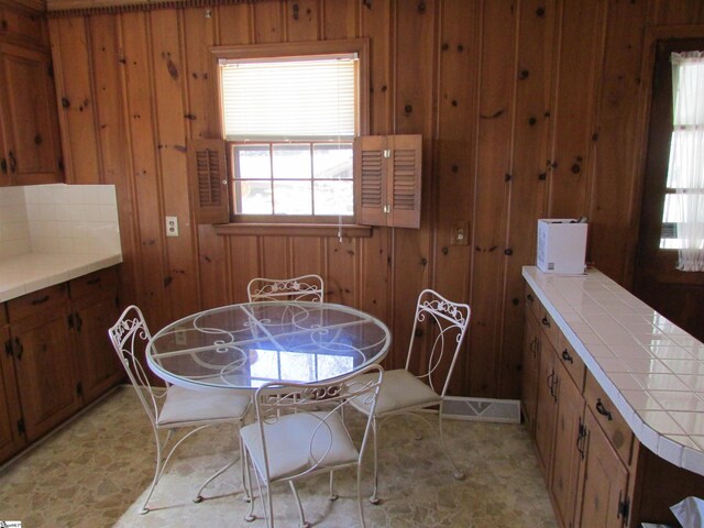 dining room with wooden walls