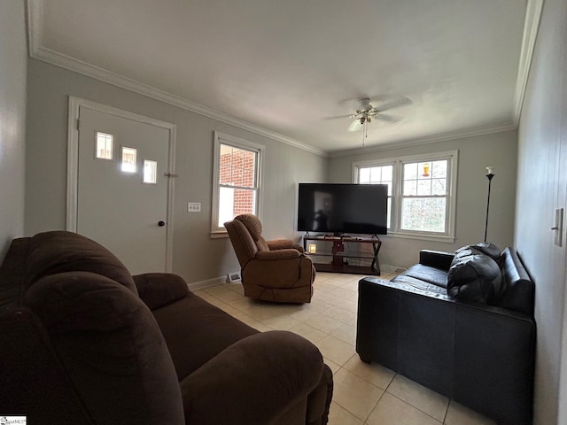 living room with light tile patterned floors, a healthy amount of sunlight, and ornamental molding