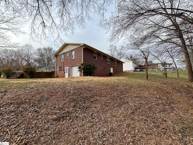 view of home's exterior featuring brick siding and an attached garage