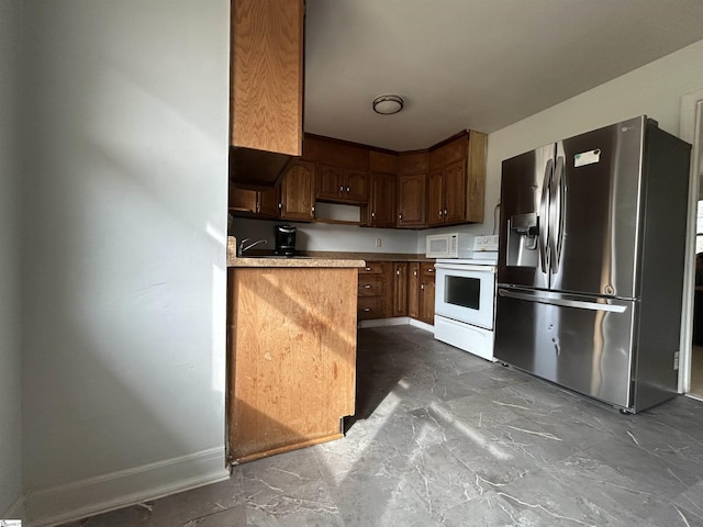 kitchen featuring white appliances, light countertops, baseboards, and marble finish floor